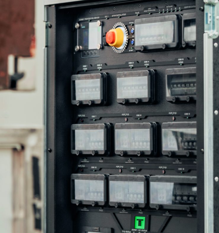 Custom power distribution panel with an emergency stop and circuit breaker windows.