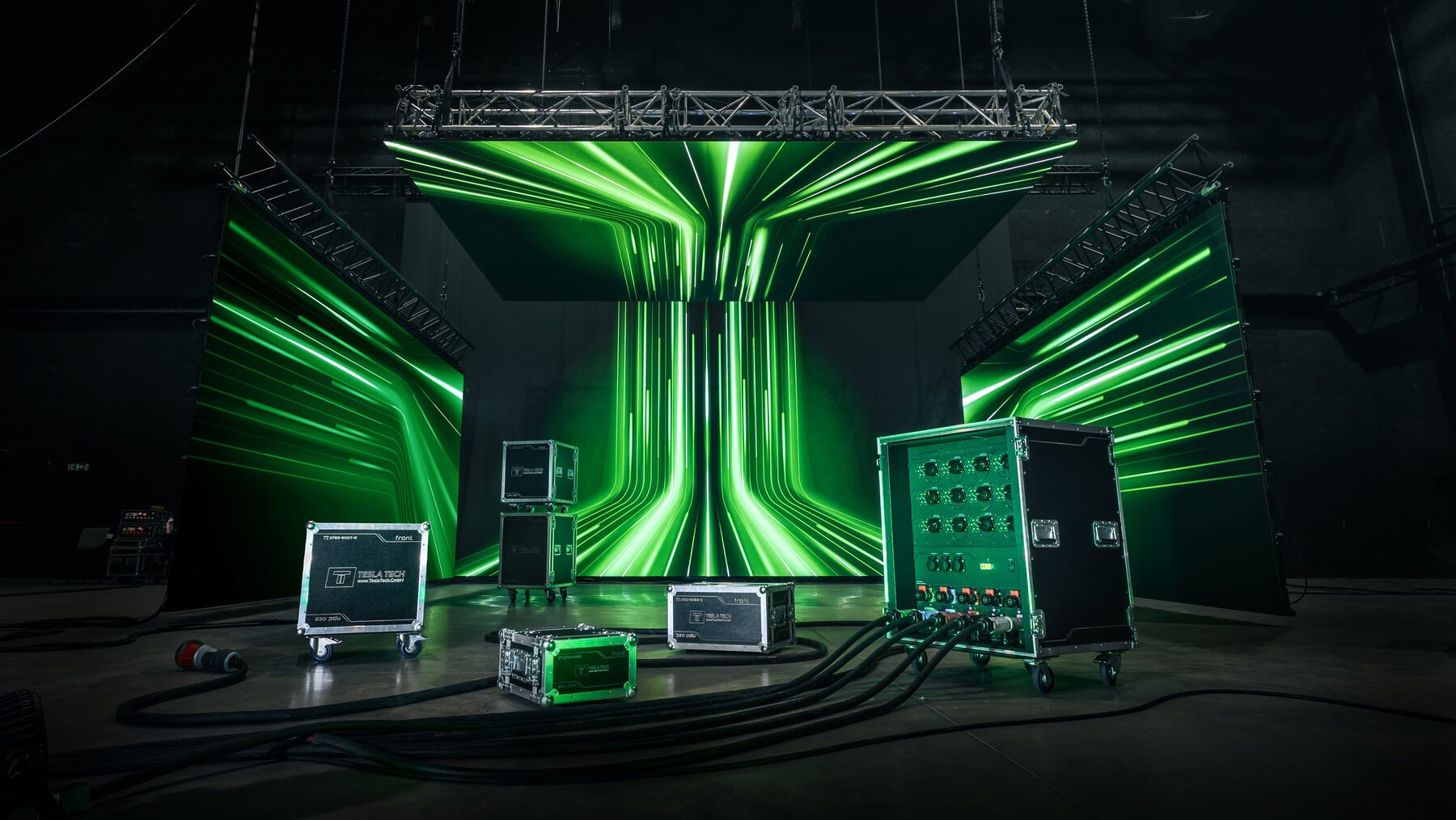 Stage scene with green lighting, overhead truss and a flightcase power distribution unit.