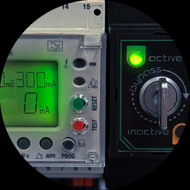 Residual current monitor beside a bypass selector on a PDU control panel.